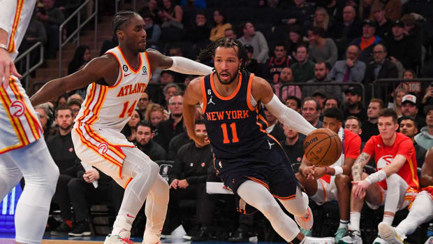 Knicks guard Jalen Brunson dribbles past Hawks forward AJ Griffin.